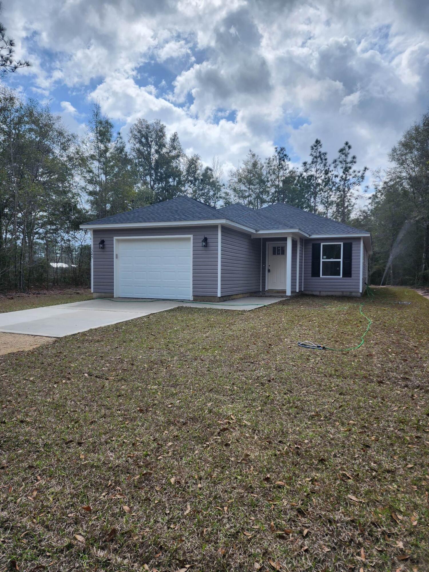 1249 Martin Road DeFuniak Springs, FL 32433 - Photo 1 of 15 a front view of house with yard and trees all around