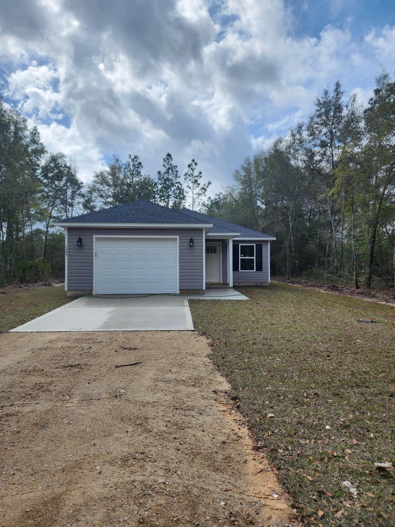 1249 Martin Road DeFuniak Springs, FL 32433 - Photo 13 of 15 front view of a house with a yard and a garage