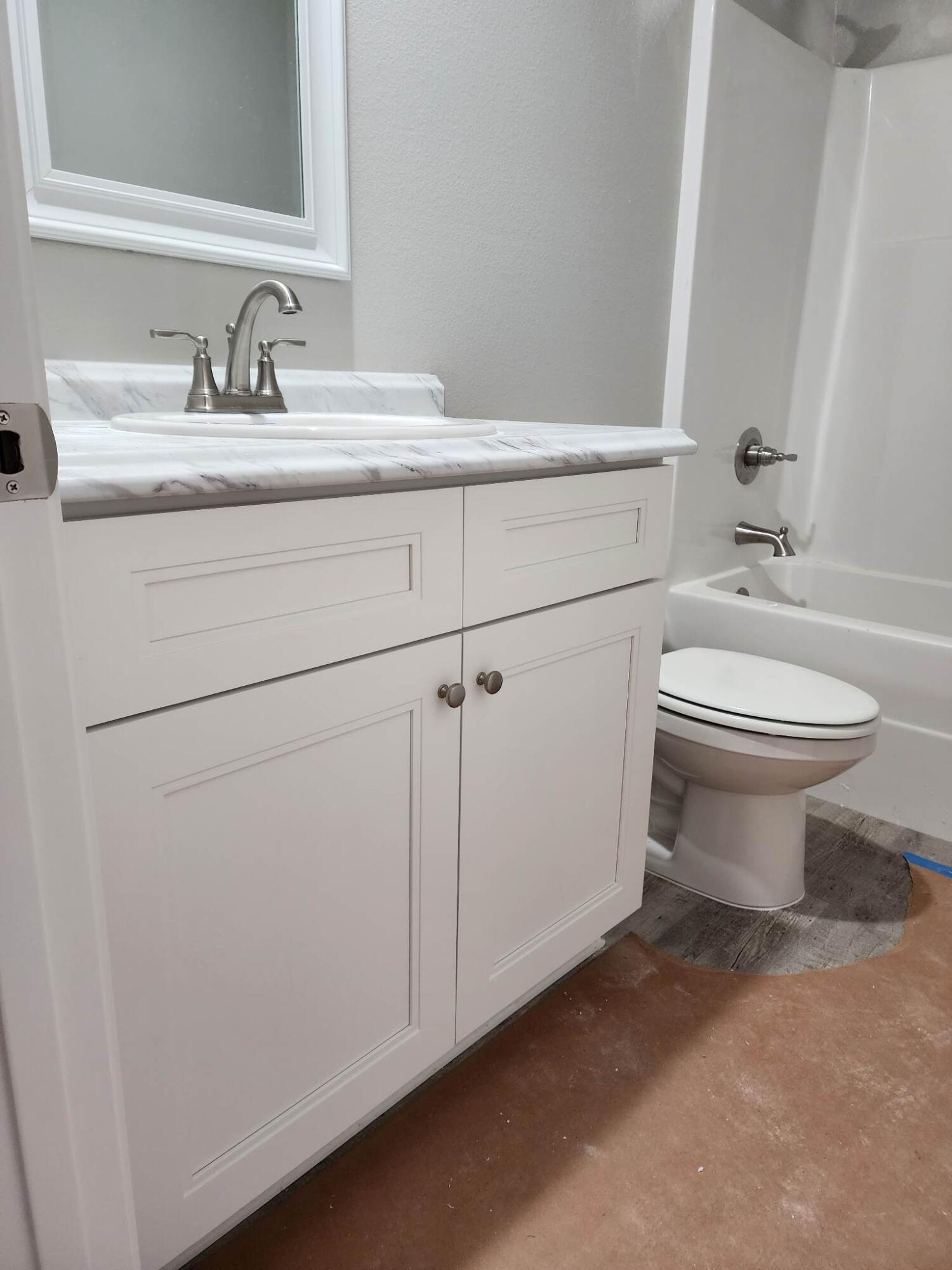 1249 Martin Road DeFuniak Springs, FL 32433 - Photo 8 of 15 a bathroom with a toilet sink and mirror