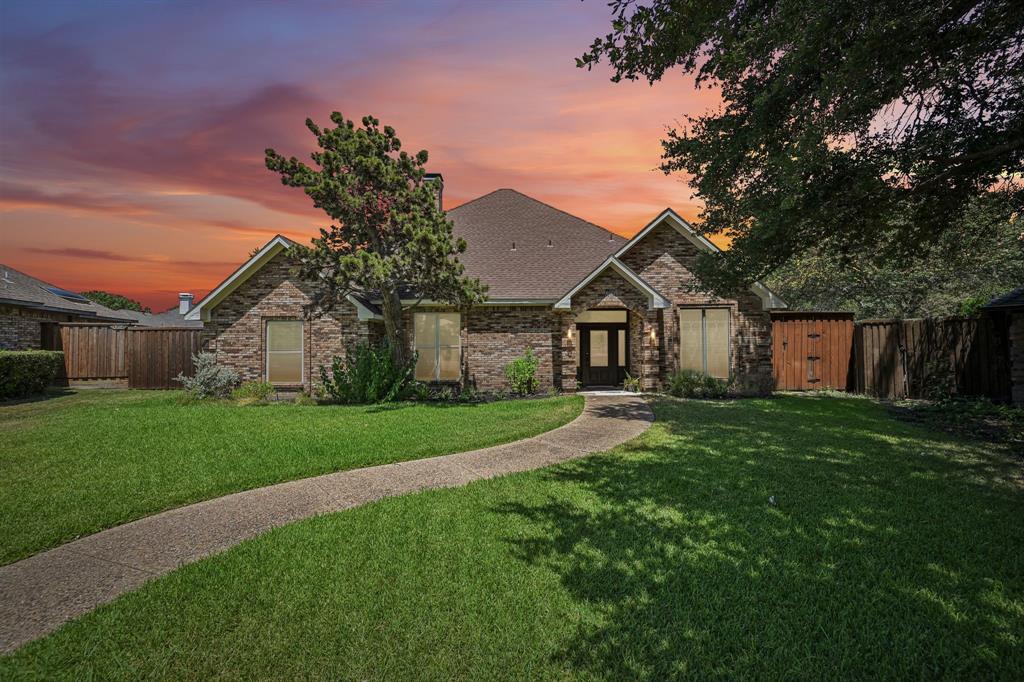 925 Spring Brook Drive Allen, TX 75002 - Photo 1 of 30 Brick exterior, gabled roofline, double entry doors, front walkway, and a manicured lawn