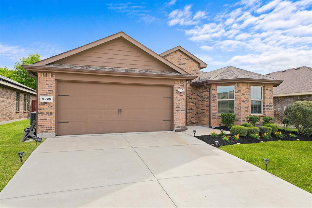 9020 Ridgeriver Way Fort Worth, TX 76131 - Photo 2 of 26 a front view of a house with a yard and garage