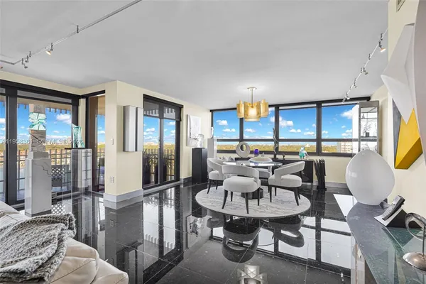 a living room with furniture and a floor to ceiling window