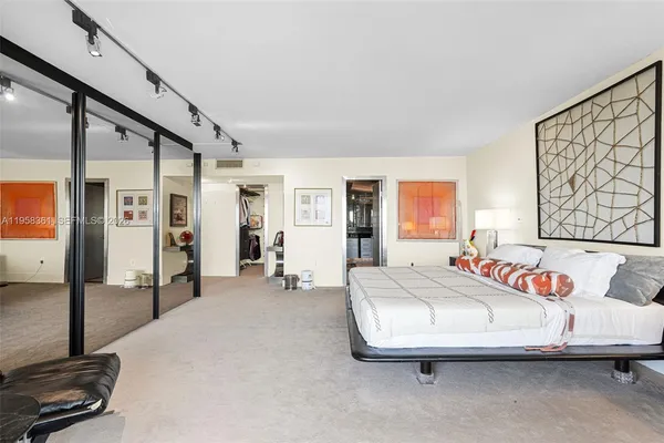 a vase of flowers sitting on a table with chairs