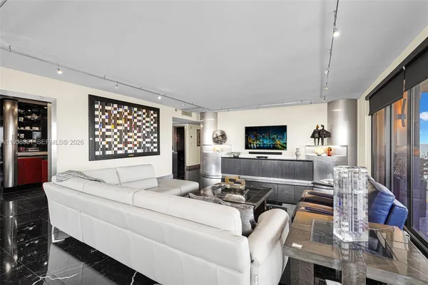 a dining room with furniture and chandelier