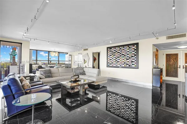 a living room with fireplace furniture and a large window