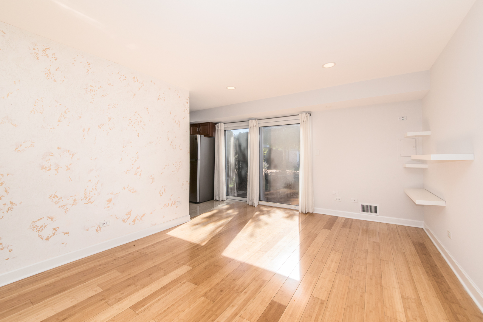 26 Cour Versaille, Unit 26 Palos Hills, IL 60465 - Photo 11 of 24 a view of an empty room with wooden floor and a window