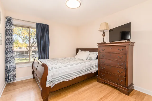 a bedroom with a bed and flat screen tv
