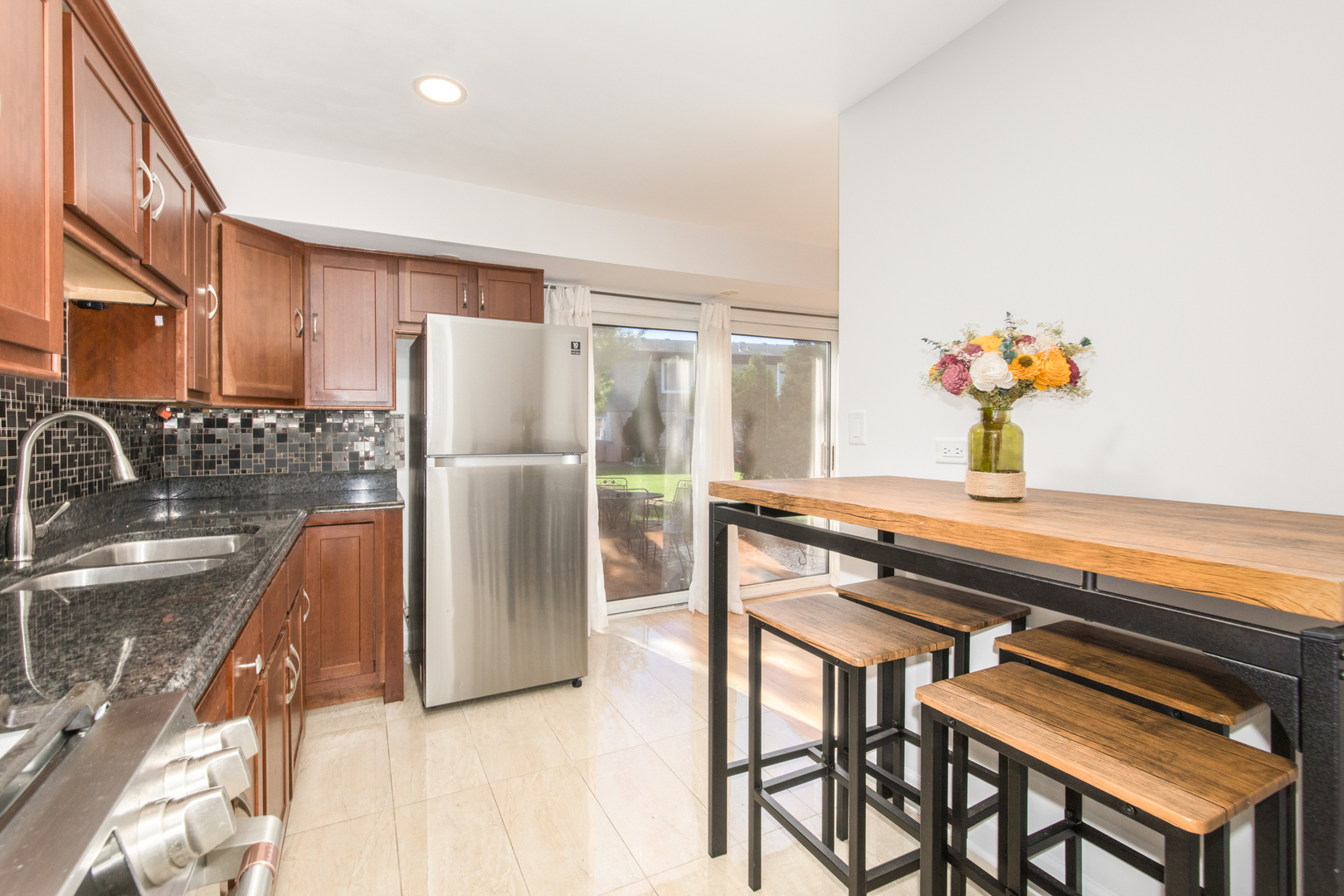 26 Cour Versaille, Unit 26 Palos Hills, IL 60465 - Photo 5 of 24 a kitchen with stainless steel appliances granite countertop a refrigerator and a sink