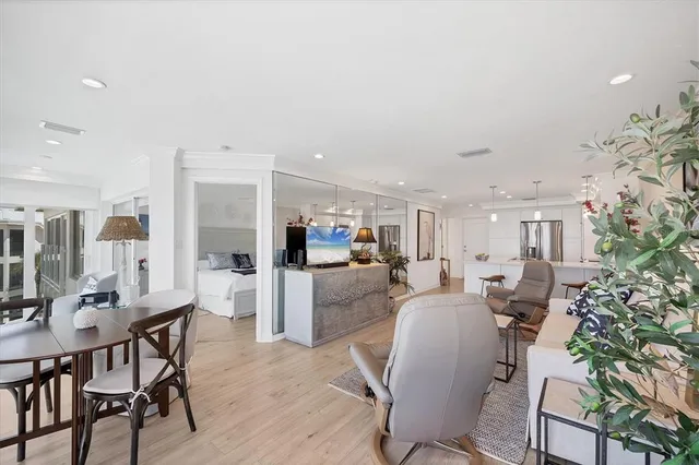 a living room with furniture a dining table and chairs with kitchen view
