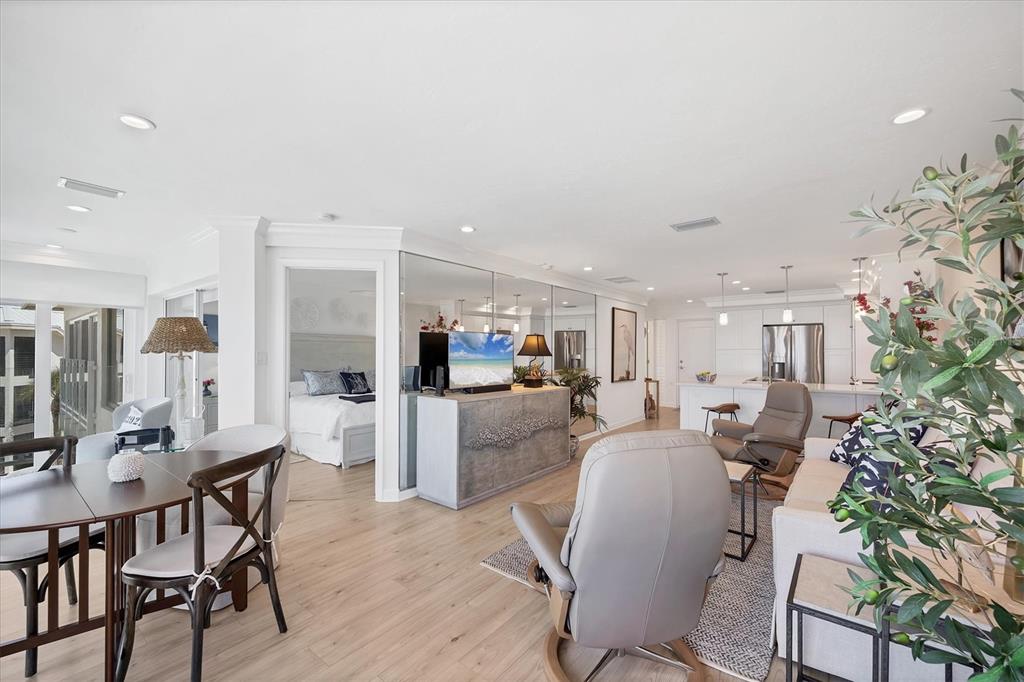 5000 Gasparilla Road, Unit 304 Boca Grande, FL 33921 - Photo 11 of 30 a living room with furniture a dining table and chairs with kitchen view