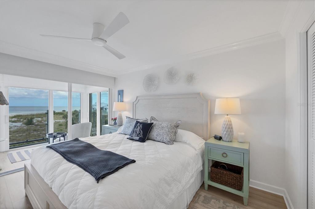 5000 Gasparilla Road, Unit 304 Boca Grande, FL 33921 - Photo 16 of 30 a bedroom with a large bed and a lamp on table