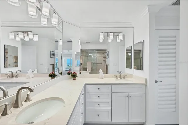 a bathroom with double vanity sinks and a mirror