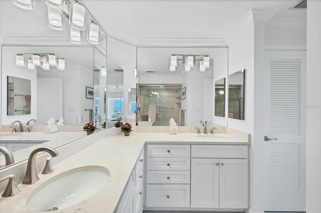 5000 Gasparilla Road, Unit 304 Boca Grande, FL 33921 - Photo 21 of 30 a bathroom with double vanity sinks and a mirror