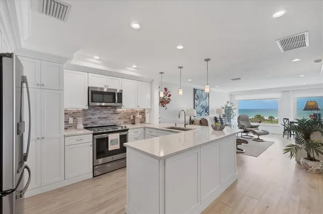 a kitchen with appliances a sink and cabinets
