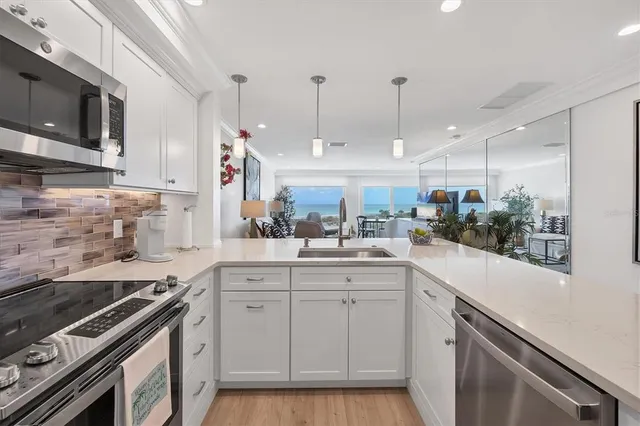 a kitchen with a sink stove and microwave