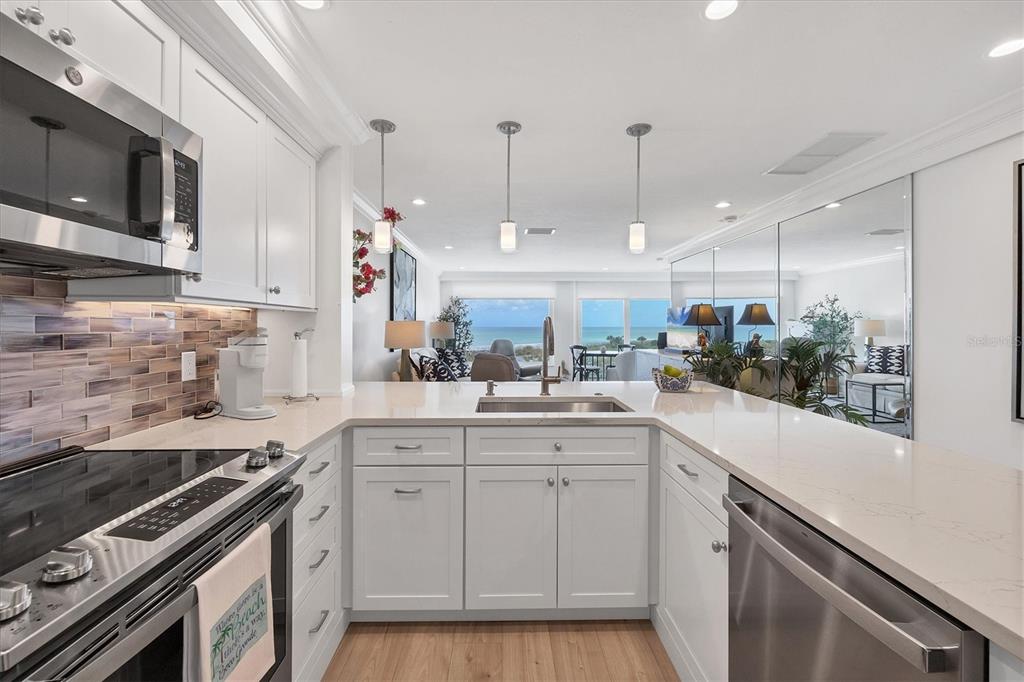 5000 Gasparilla Road, Unit 304 Boca Grande, FL 33921 - Photo 6 of 30 a kitchen with a sink stove and microwave