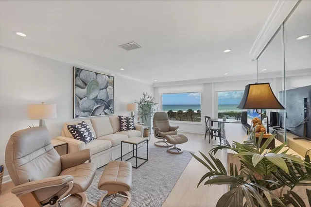 a living room with furniture a rug and a lamp