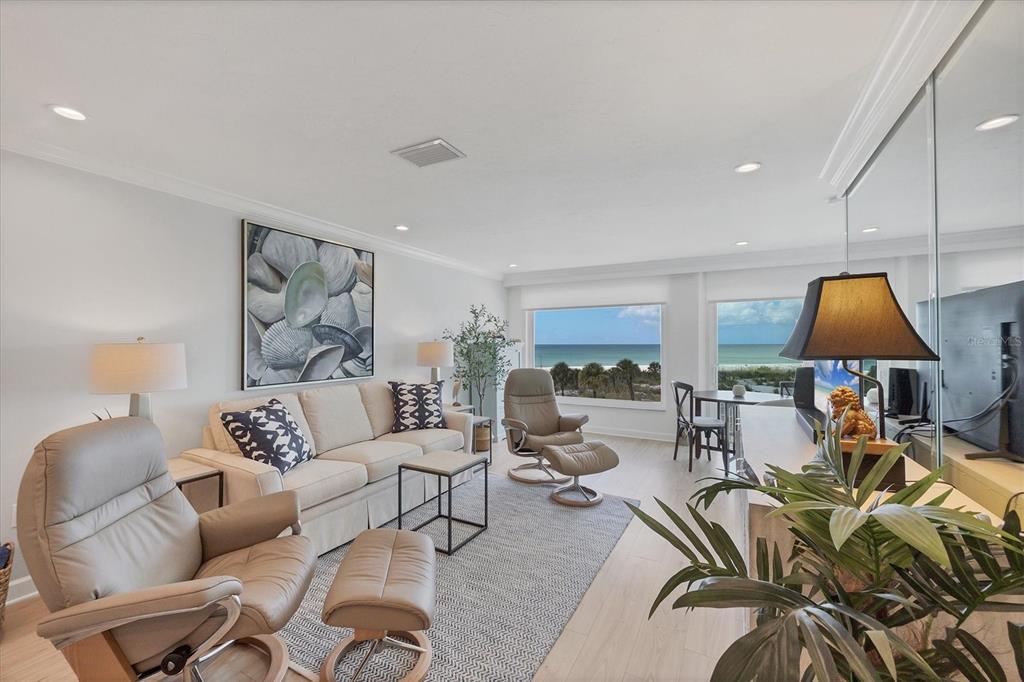 5000 Gasparilla Road, Unit 304 Boca Grande, FL 33921 - Photo 8 of 30 a living room with furniture a rug and a lamp