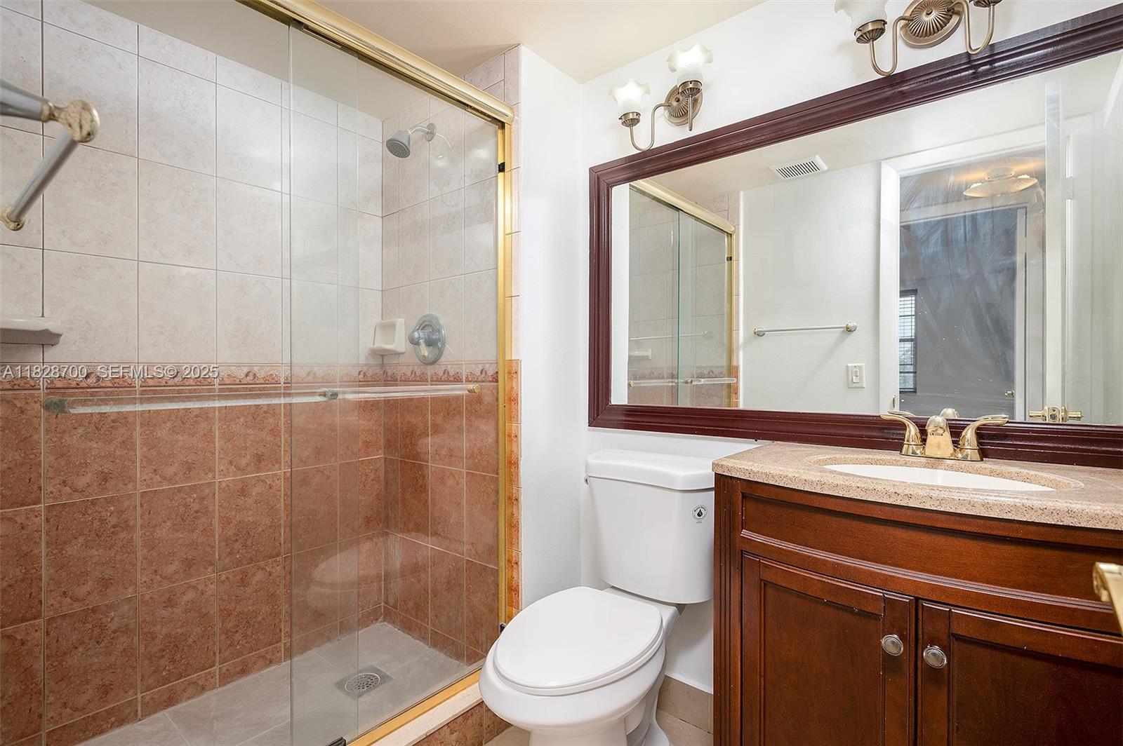 3150 West Rolling Hills Circle, Unit 307 Davie, FL 33328 - Photo 11 of 20 a bathroom with a sink a toilet and shower