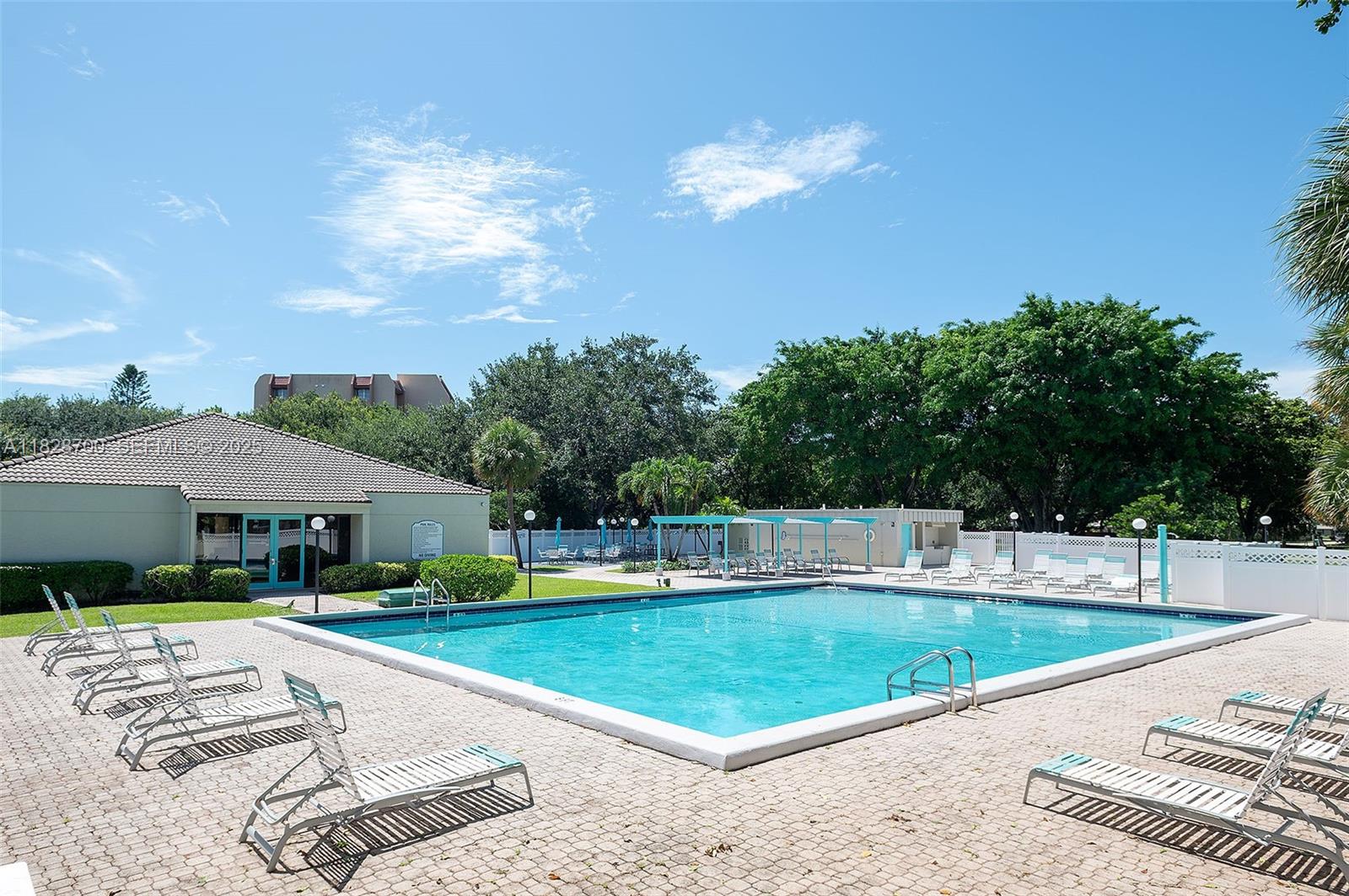 3150 West Rolling Hills Circle, Unit 307 Davie, FL 33328 - Photo 20 of 20 a view of a house with swimming pool and a yard