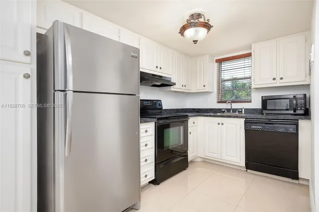 a white refrigerator freezer sitting in a kitchen