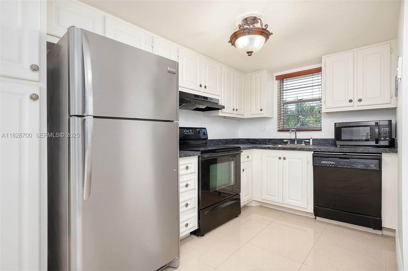 3150 West Rolling Hills Circle, Unit 307 Davie, FL 33328 - Photo 5 of 20 a kitchen with a refrigerator stove and sink