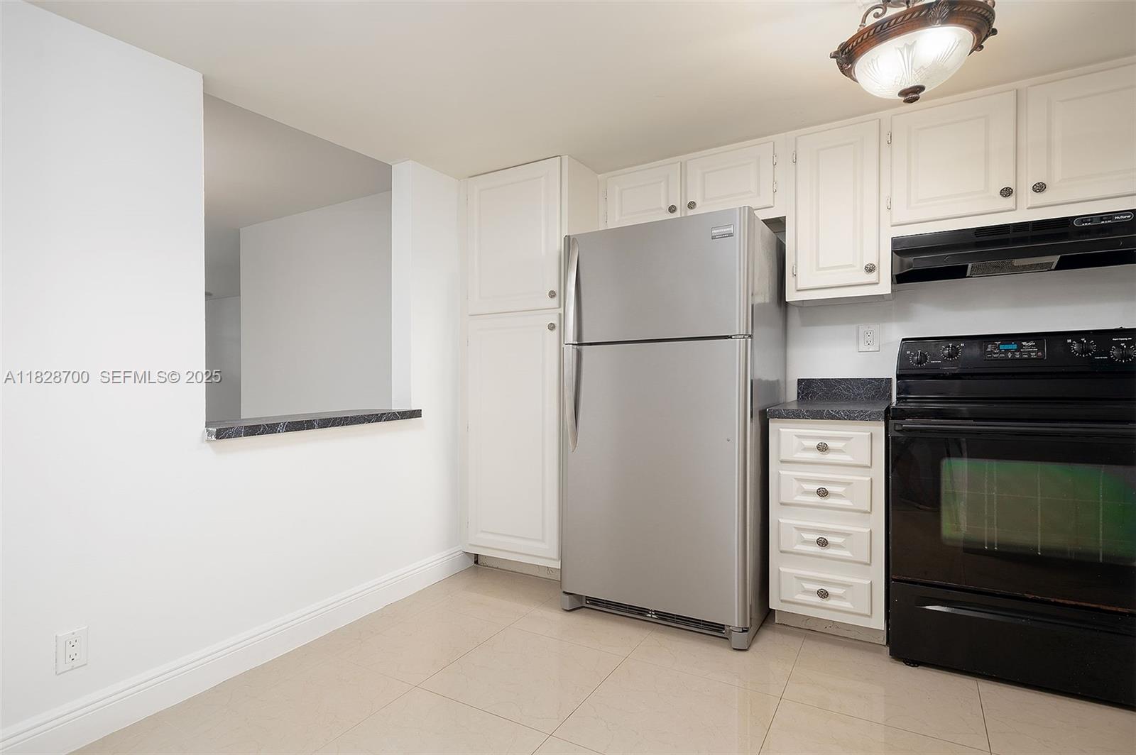 3150 West Rolling Hills Circle, Unit 307 Davie, FL 33328 - Photo 6 of 20 a white refrigerator freezer sitting in a kitchen