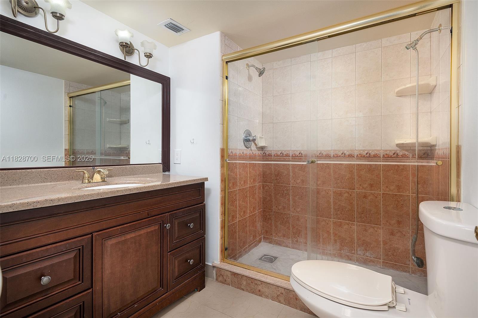 3150 West Rolling Hills Circle, Unit 307 Davie, FL 33328 - Photo 8 of 20 a bathroom with a sink a toilet and shower