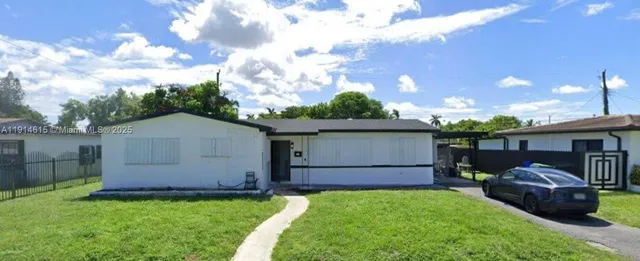 a front view of a house with a garden and yard