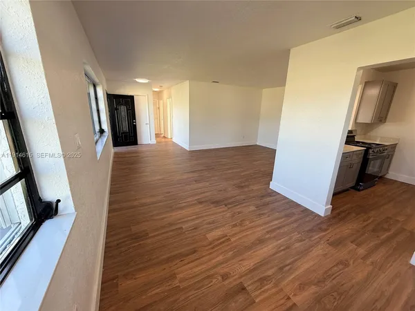 a view of a kitchen from a hallway