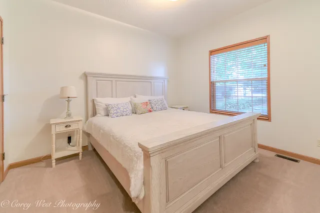 a bedroom with a bed and a night stand