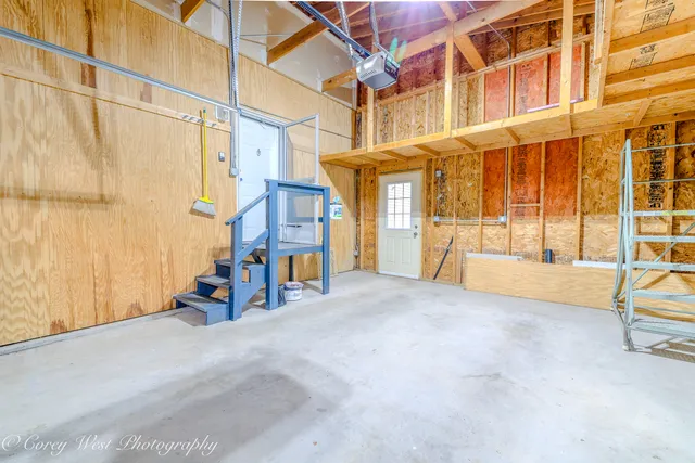 a hallway with wooden floor and a table