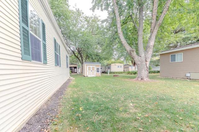 a view of a backyard with a large tree