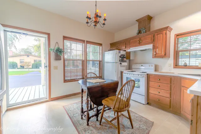 a dining room with furniture a window and a kitchen view