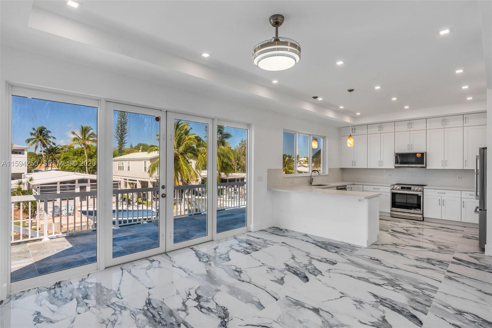 84 Coral Way Key Largo, FL 33037 - Photo 9 of 55 a kitchen with a table and chairs in it