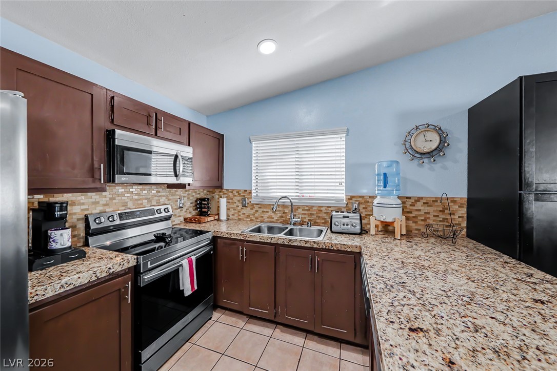 3107 Trueno Road Henderson, NV 89014 - Photo 18 of 37 Granite counters and stainless steel appliances complete this compact, functional kitchen.