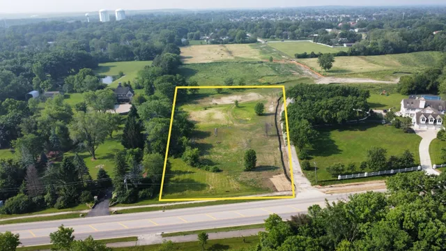 an aerial view of residential houses with outdoor space and street view