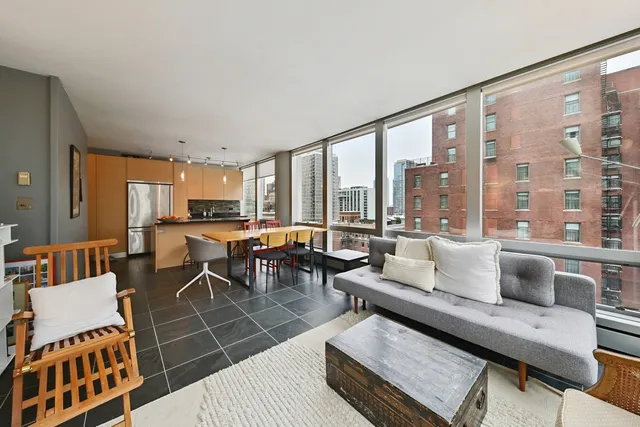 a living room with furniture and a floor to ceiling window