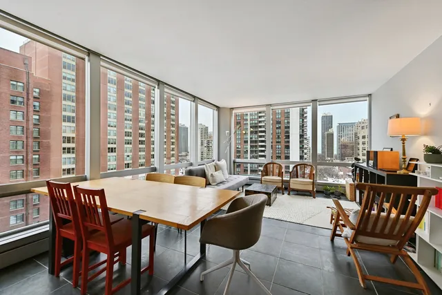 a dining room with furniture a chandelier and wooden floor