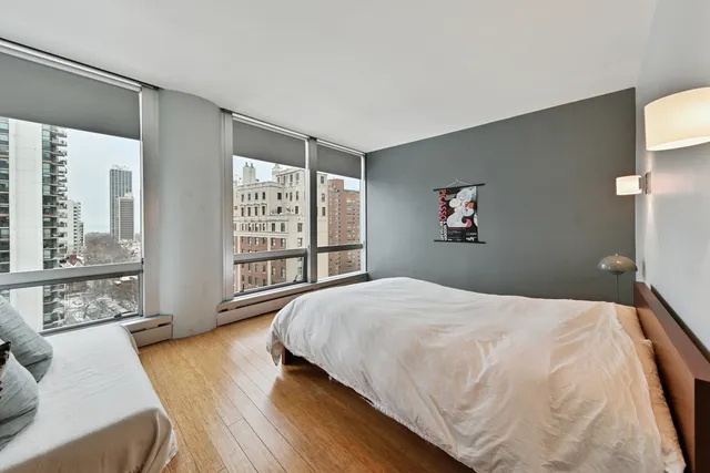 a bedroom with a large bed and a large window