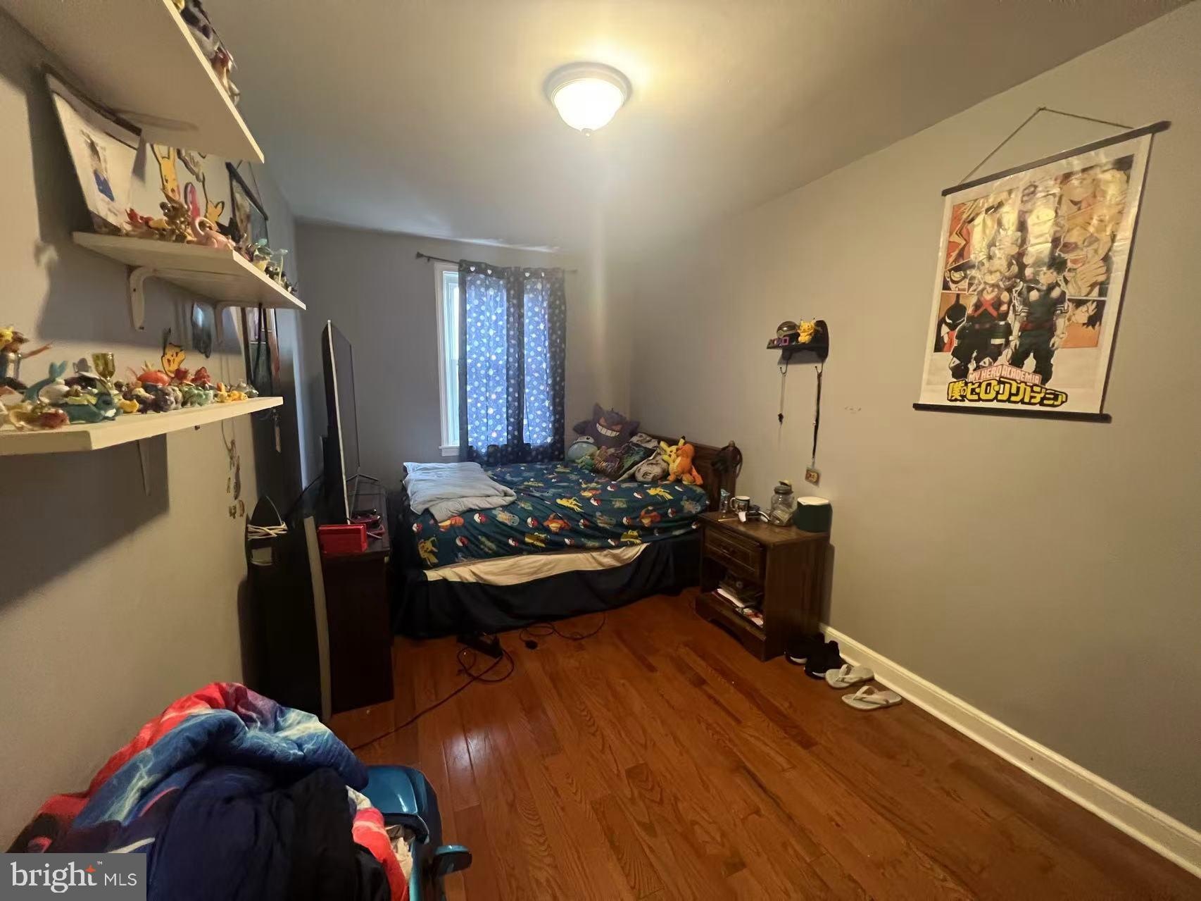 3147 Friendship Street Philadelphia, PA 19149 - Photo 13 of 16 a bedroom with a bed and wooden floor