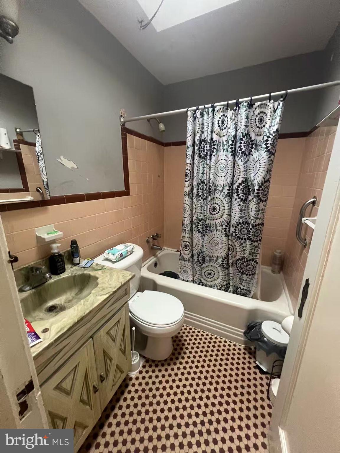 3147 Friendship Street Philadelphia, PA 19149 - Photo 14 of 16 a bathroom with a granite countertop toilet sink and a shower