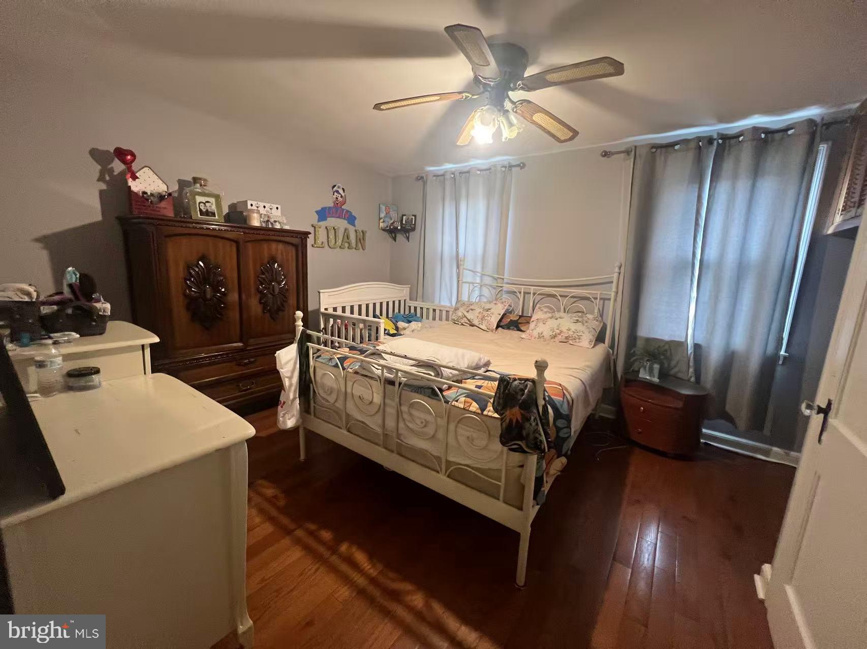 3147 Friendship Street Philadelphia, PA 19149 - Photo 15 of 16 a bedroom with a bed and a chandelier