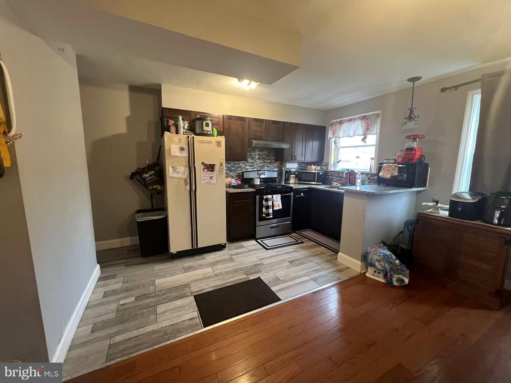 3147 Friendship Street Philadelphia, PA 19149 - Photo 6 of 16 a kitchen with stainless steel appliances kitchen island granite countertop a refrigerator stove and sink