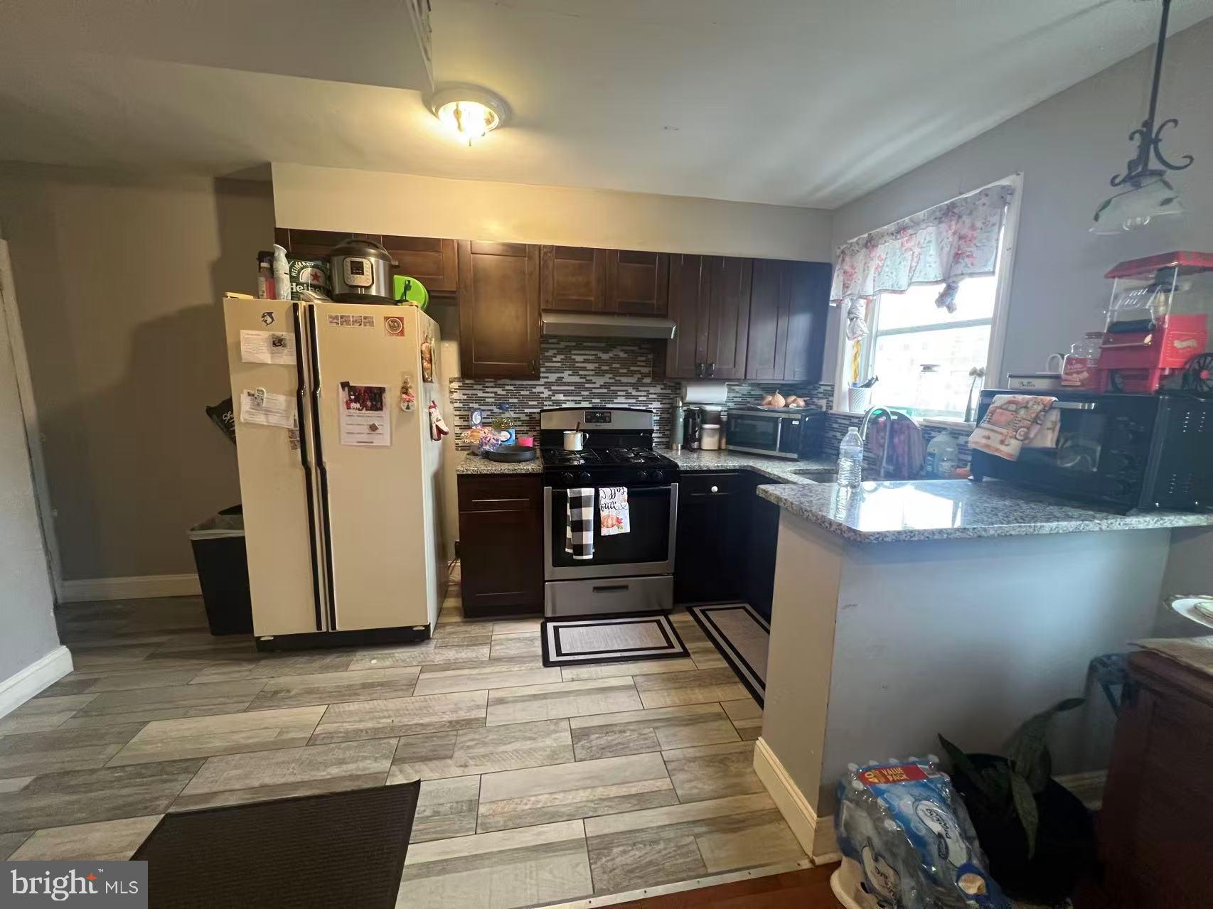 3147 Friendship Street Philadelphia, PA 19149 - Photo 7 of 16 a kitchen with stainless steel appliances granite countertop a refrigerator and a sink