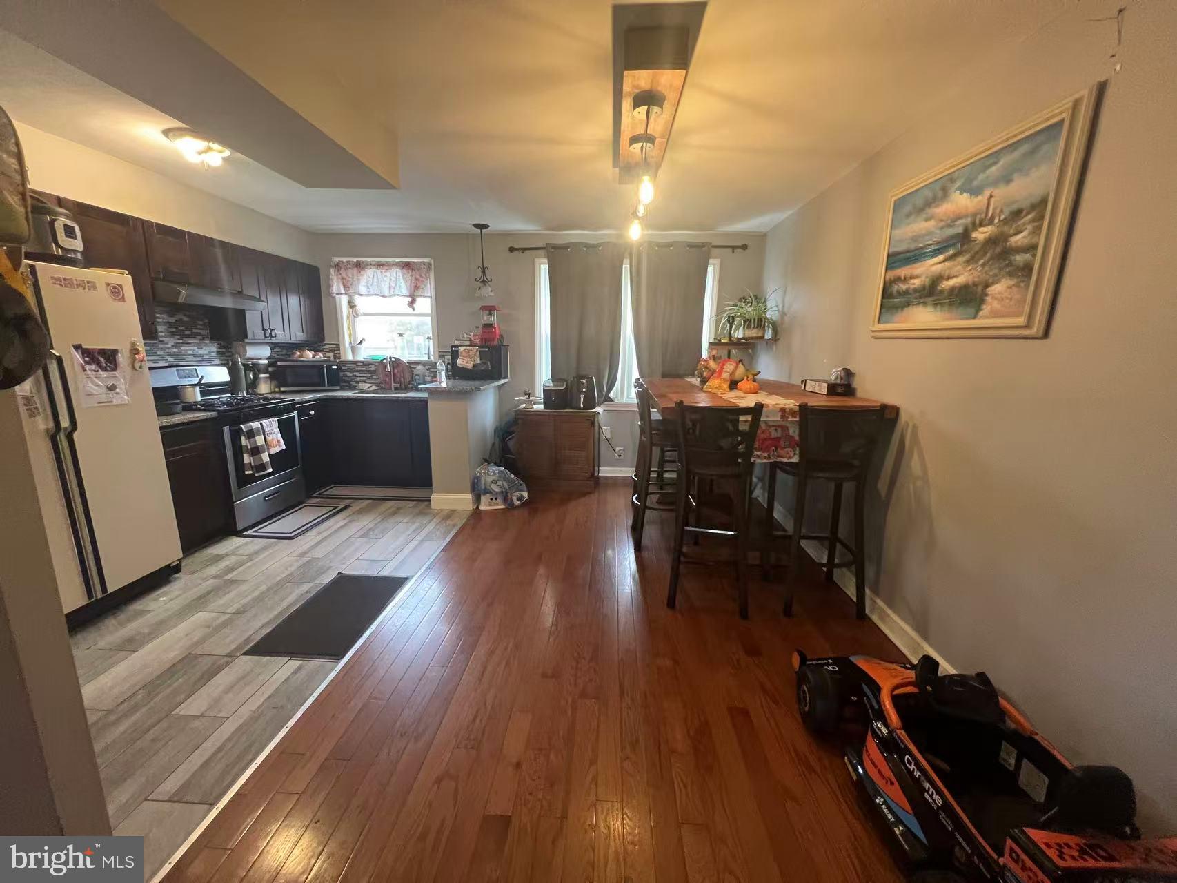 3147 Friendship Street Philadelphia, PA 19149 - Photo 8 of 16 a view of a dining room with furniture a chandelier and wooden floor