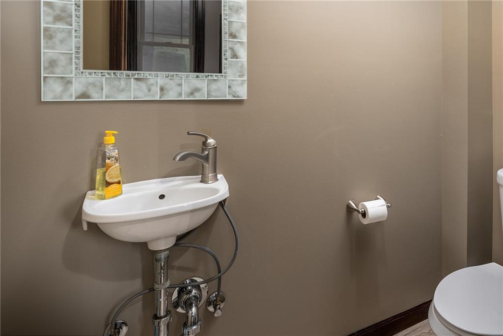 838 Spring Garden Avenue Pittsburgh, PA 15212 - Photo 13 of 24 a bathroom with a sink a toilet and mirror