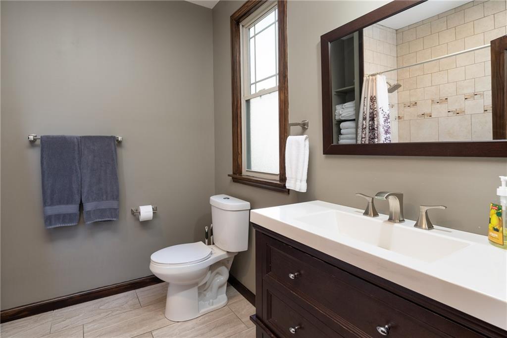 838 Spring Garden Avenue Pittsburgh, PA 15212 - Photo 18 of 24 a bathroom with a toilet sink and mirror