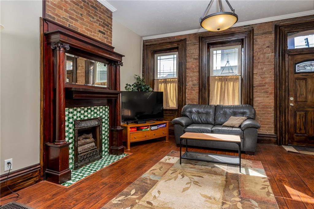 838 Spring Garden Avenue Pittsburgh, PA 15212 - Photo 2 of 24 a living room with fireplace furniture and a flat screen tv
