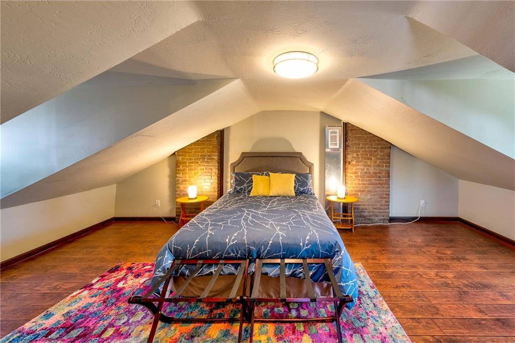 838 Spring Garden Avenue Pittsburgh, PA 15212 - Photo 21 of 24 a bedroom with a bed and a potted plant